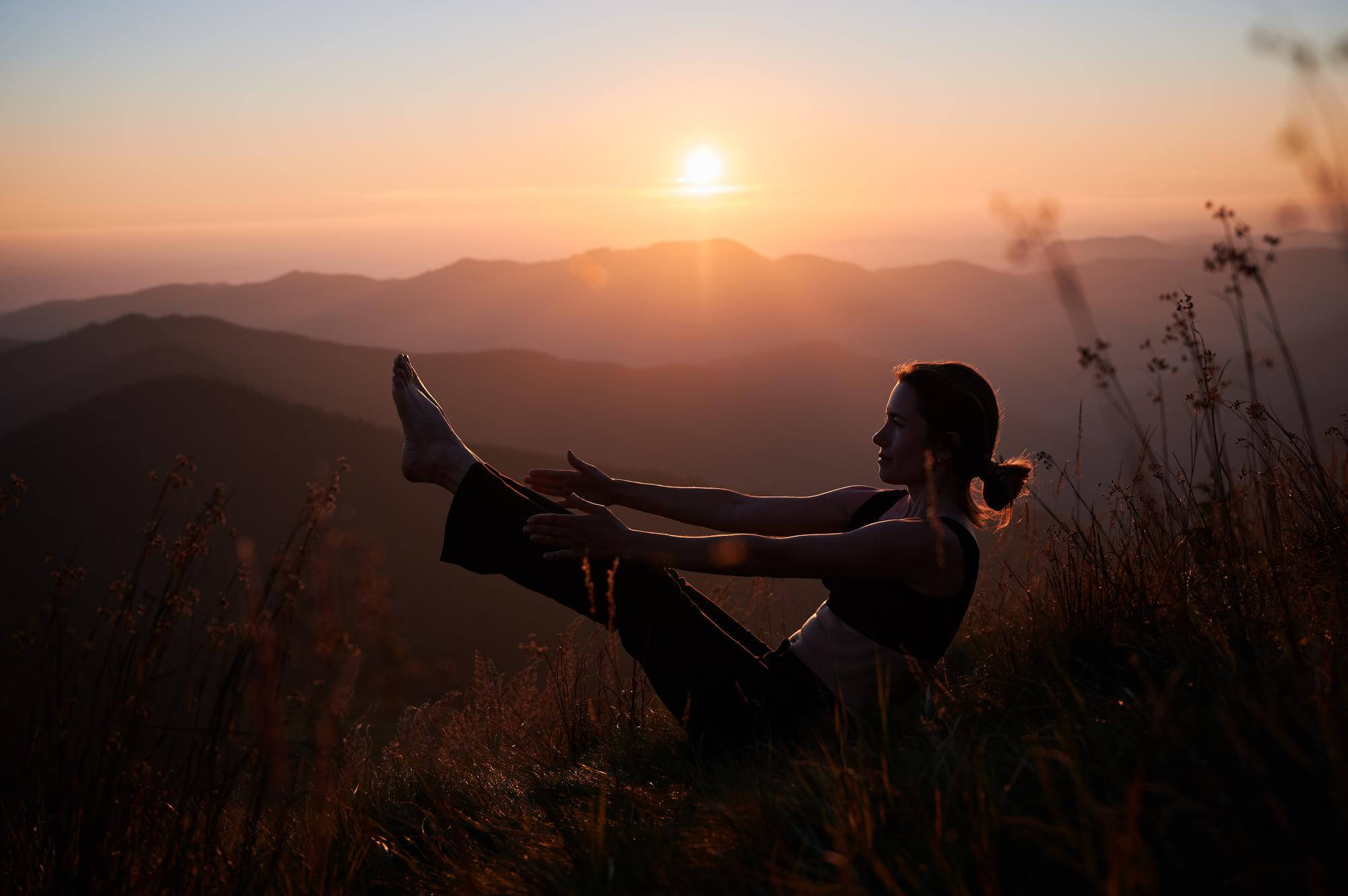 Woman meditating in the mountains